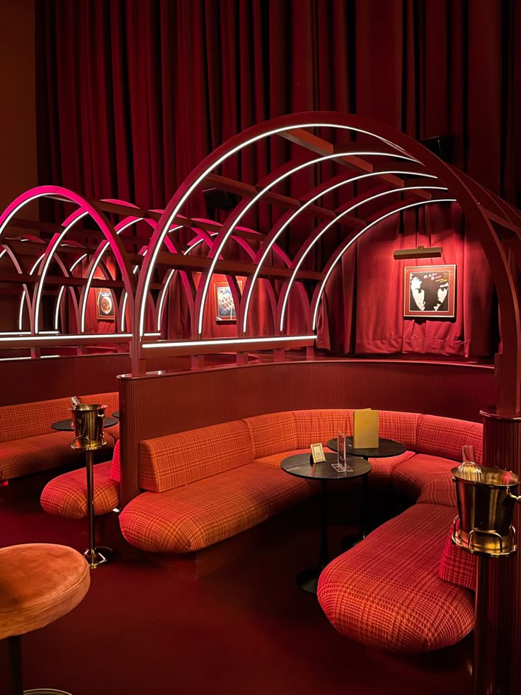 Luxurious red VIP lounge with arched booths and champagne