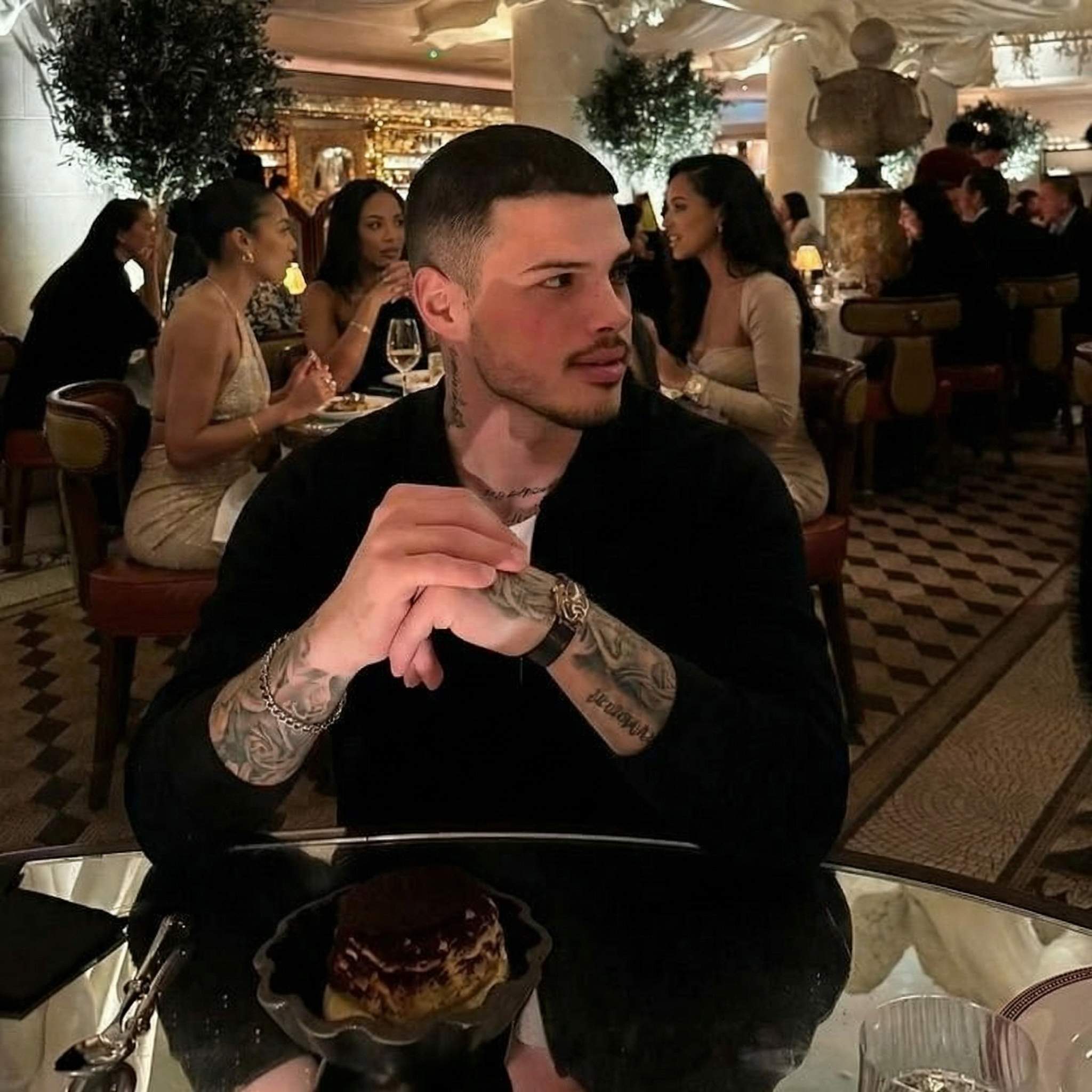 Man at elegant restaurant with tiramisu dessert